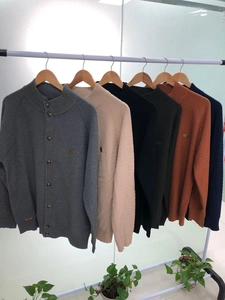 Detail showing the waffle knit texture and ribbed cuffs of various men's cardigans