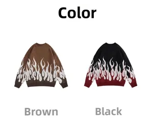 Detail eines Strickpullovers mit markantem Flammen-Jacquardmuster am Saum und Rippbündchen