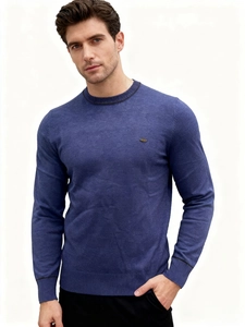 Detail view of navy blue knit sweater featuring ribbed collar with black stripe accents