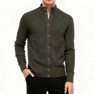 Detail of dark olive knit cardigan showing ribbed stand collar and brown buttons