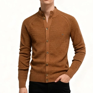Macro view of caramel knit cardigan featuring sophisticated brick pattern texture