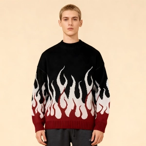 Detail eines Strickpullovers mit dreifarbigem Flammenmuster und Rippbündchen