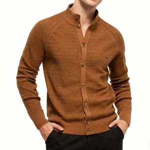Detailed macro shot of brown knit cardigan featuring stand collar and honeycomb texture fabric