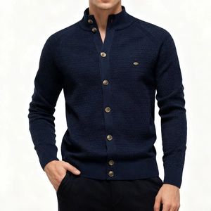 Detail of navy knit cardigan showing waffle texture, mock neck and brown buttons