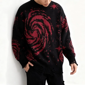 Detail view showing distressed hem with holes and fringe on the black cosmic star sweater