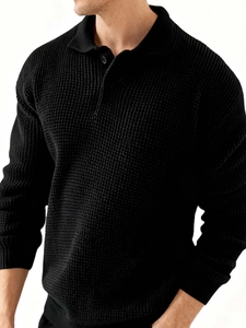 Detailed macro view of black waffle knit texture and polo collar on men's slim sweater