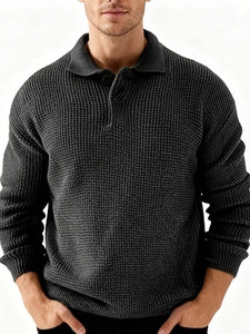 Detailed view of dark grey waffle knit texture and three-button polo collar design