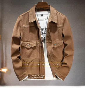 Detail view of a vintage brown workwear denim jacket featuring large flap utility pockets