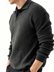 Detail of charcoal grey waffle knit texture and buttoned polo collar on men's long sleeve shirt