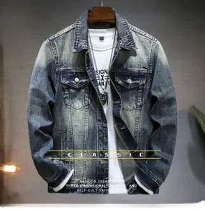 Detail of vintage blue washed denim jacket featuring distressed edges and chest pockets