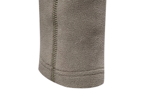 Détail de la texture polaire grise avec couture à double aiguille sur le bord de la manche