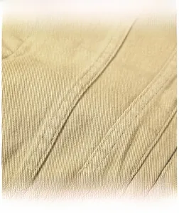 Close-up of premium khaki twill cotton fabric texture with precise stitching craftsmanship