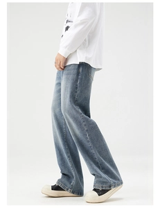 Side view of men's vintage blue straight leg jeans with authentic washed texture detail