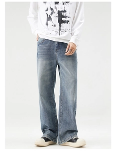 Relaxed fit light blue washed straight denim jeans worn by a model in a studio setting