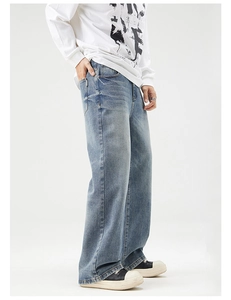 Side view of men's wide-leg light blue washed jeans with vintage distressed finish