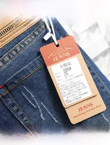Detail of dark blue stretch denim jeans showing fashion leather label and fabric tag