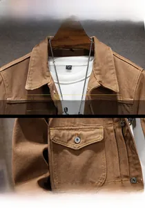 Detail view of the brown canvas work jacket showing vintage collar and shield flap pocket