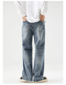 Rear view of loose fit blue denim jeans showing symmetrical pockets and washed texture