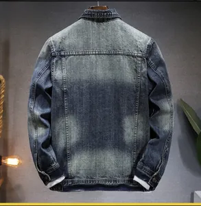 Rear view of vintage wash denim jacket showing detailed stitching and distressed texture