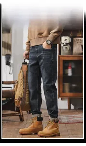 Detail view of 3D tailored men's dark blue washed denim jeans with vintage whiskers