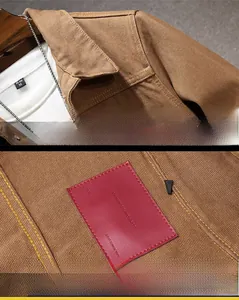 Detail of brown workwear jacket featuring shoulder stitching and a leather interior brand tag