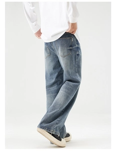 Detail of baggy retro washed blue denim jeans showing rear pockets and loose fit silhouette