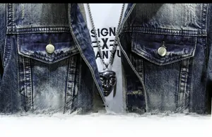 Detail view of retro washed blue denim jacket with flap pockets and metal buttons