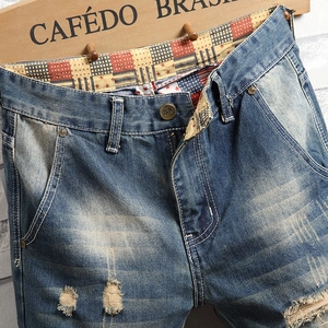 Men's vintage distressed slim fit denim jeans with unique patterned pocket lining details