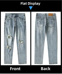 Flat lay of light blue distressed jeans with ripped details and back leather patch