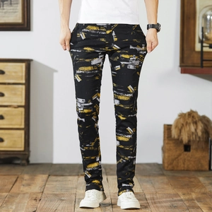 Men's slim fit casual trousers with yellow and white abstract paint prints on black fabric