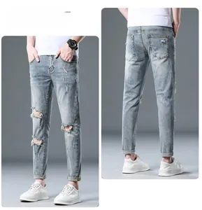 Front and back view of men's slim fit distressed blue denim jeans with ripped details