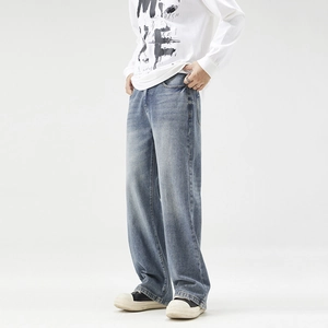 Men's loose straight-leg jeans in mid-blue washed denim with vintage fade effects