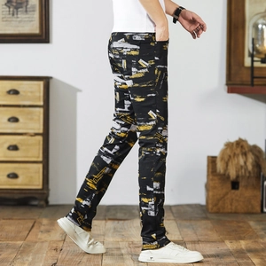 Men's slim-fit street style jeans in black with yellow and white graffiti print