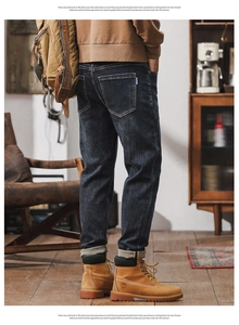 Men's retro wash dark blue straight fit jeans shown from back view with work boots