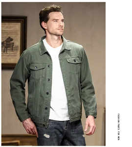 Detailed close-up of military green denim jacket with classic collar and front flap pockets