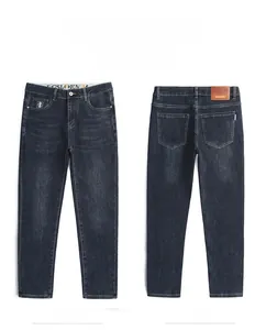 Flat lay view showing the front and back of deep blue slim fit denim jeans with leather patch