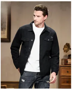Classic black men's denim jacket with flap pockets and matte buttons in indoor setting