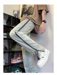 Detailed side view of light blue vintage denim pants with full-length black side zippers