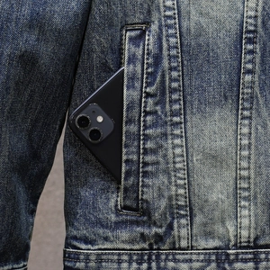 Men's washed denim jacket with functional side pockets and classic twill texture