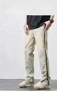 Detailed shot of knee distress and side zipper hem on men vintage straight denim pants