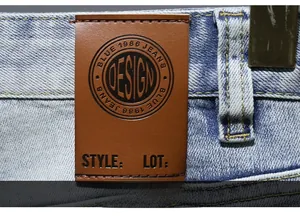 Close-up of the vintage leather back patch on light blue denim shorts for men