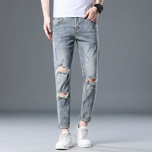 Men's slim fit distressed blue denim jeans with ripped knees and cuffed hems