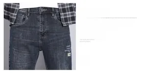 Detailed macro view of dark blue vintage wash denim waist with zipper and metal button