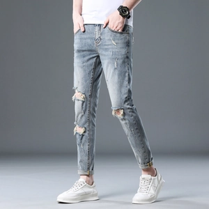 Men's slim fit distressed light blue jeans with ripped knees and street style details