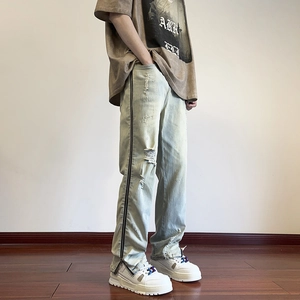 Men's vintage light wash straight jeans with full-length side zippers and distressed rips