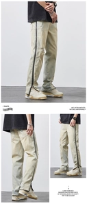 Detail of light blue distressed jeans with vertical side zipper and frayed holes