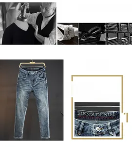 Detailed view of light blue washed denim jeans with red embroidered waist logo