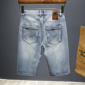 Men's vintage light blue wash denim shorts with geometric stitched back pockets