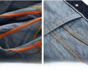 Detailed view of selvedge denim jacket with orange tape lining and contrast stitching