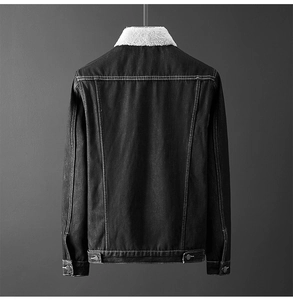 Detail view of black denim jacket with white sherpa collar and contrast stitching